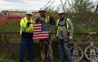 IB Abel team members holding a flag