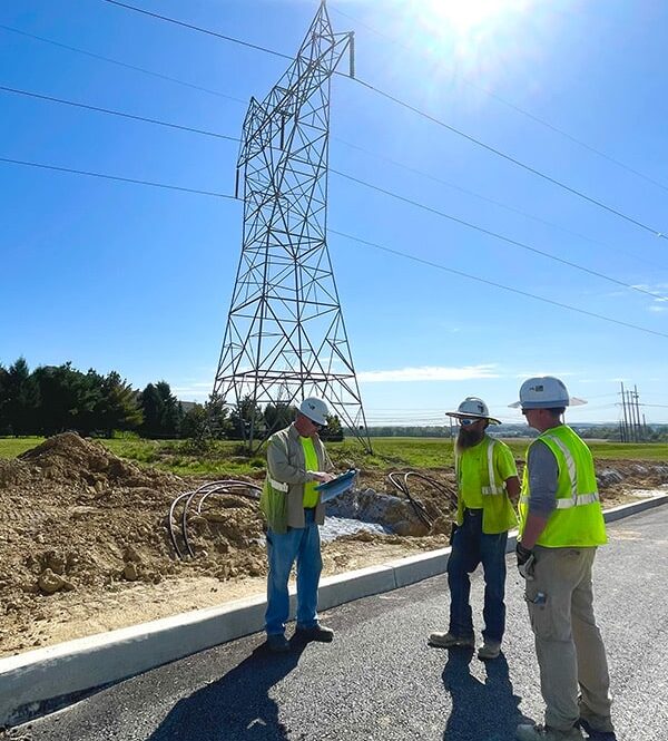 IB Abel team collaborating in front of a wireless tower